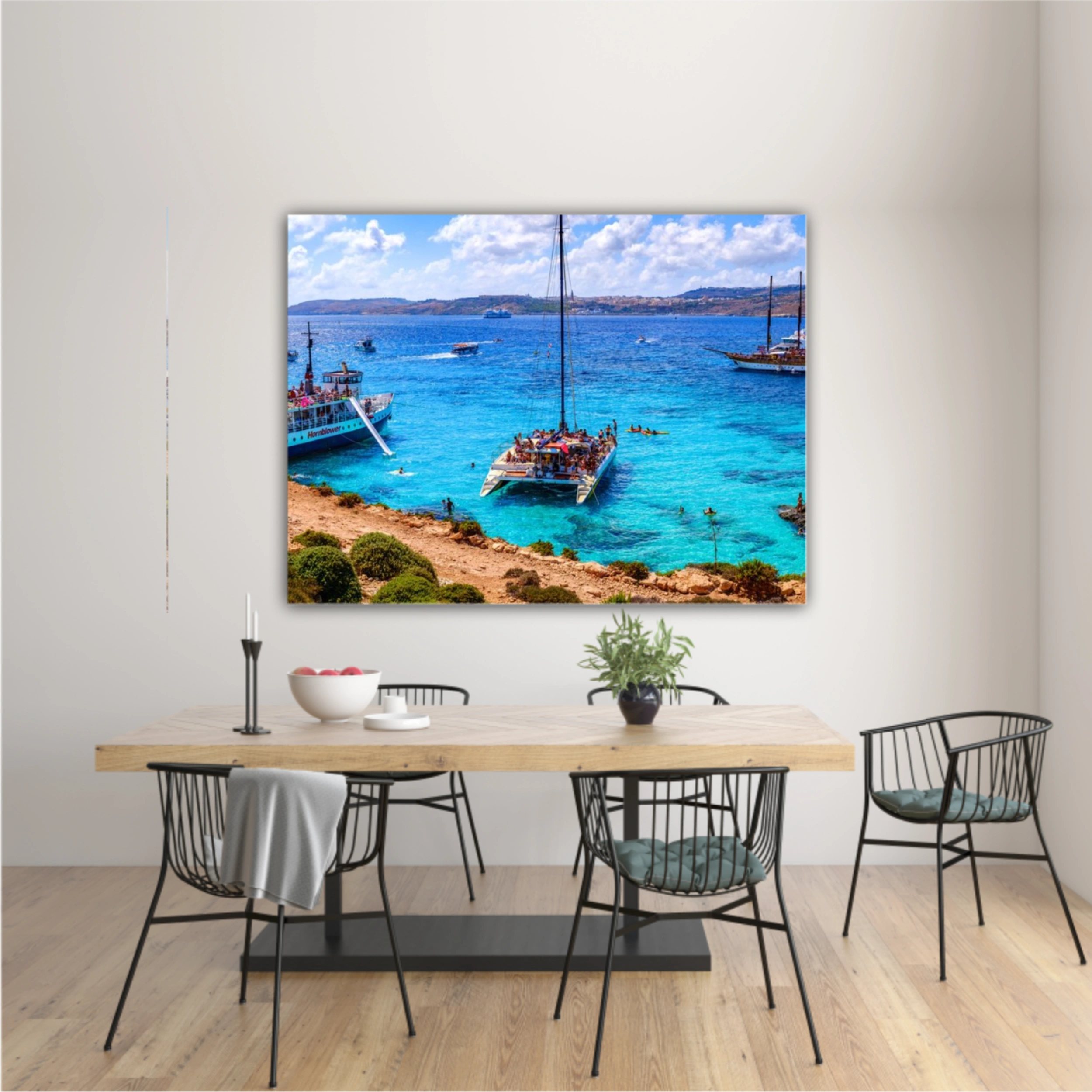 Comino, Malta. Tourists crowd at Blue Lagoon to enjoy the clear turquoise water on a sunny summer day with and boats on Comino island, Malta.