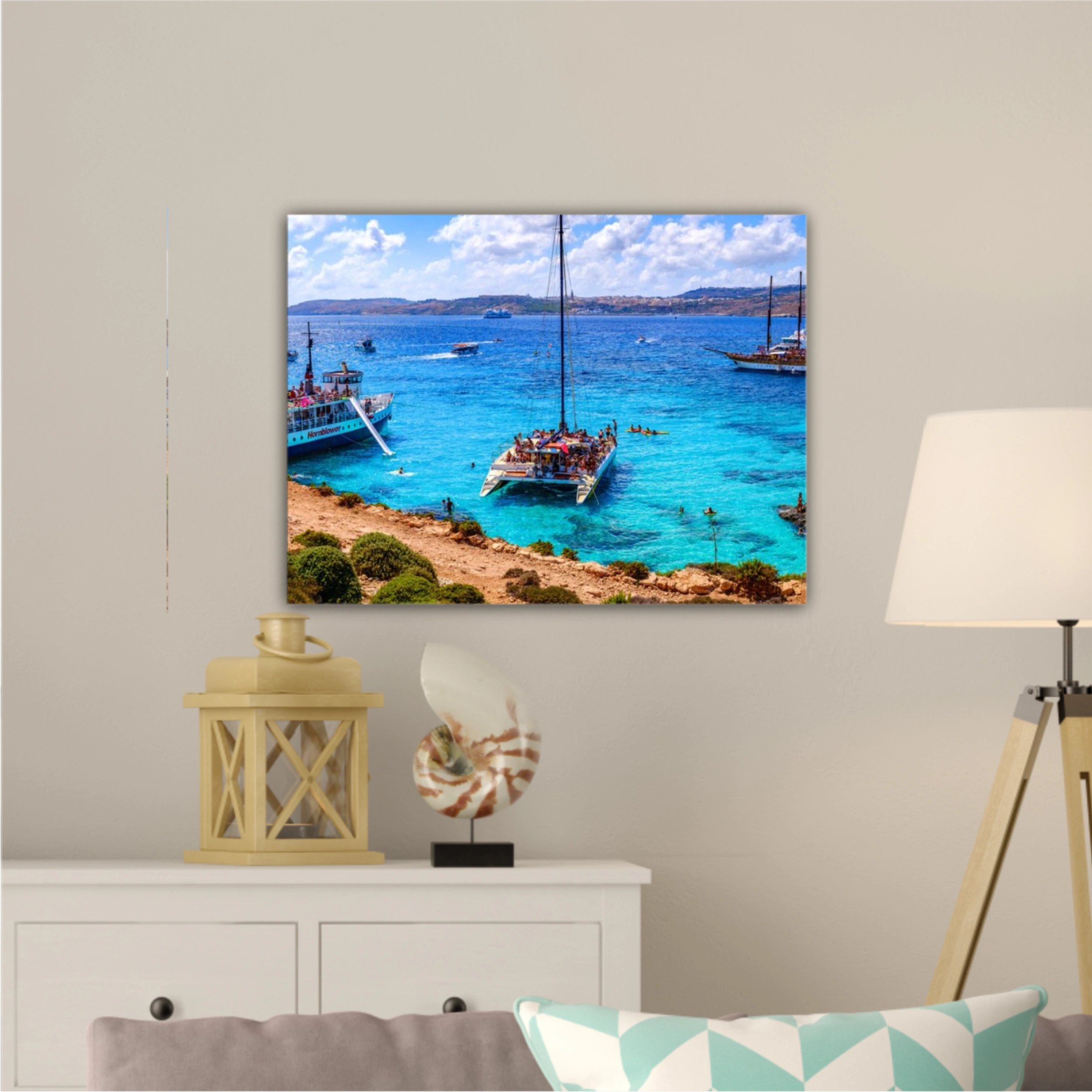 Comino, Malta. Tourists crowd at Blue Lagoon to enjoy the clear turquoise water on a sunny summer day with and boats on Comino island, Malta.