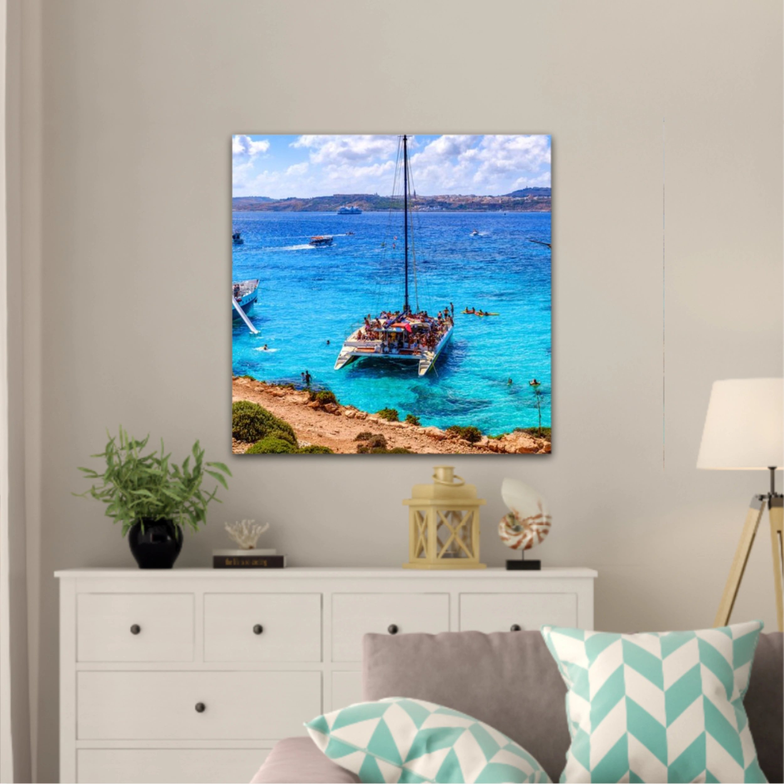 Comino, Malta. Tourists crowd at Blue Lagoon to enjoy the clear turquoise water on a sunny summer day with and boats on Comino island, Malta.