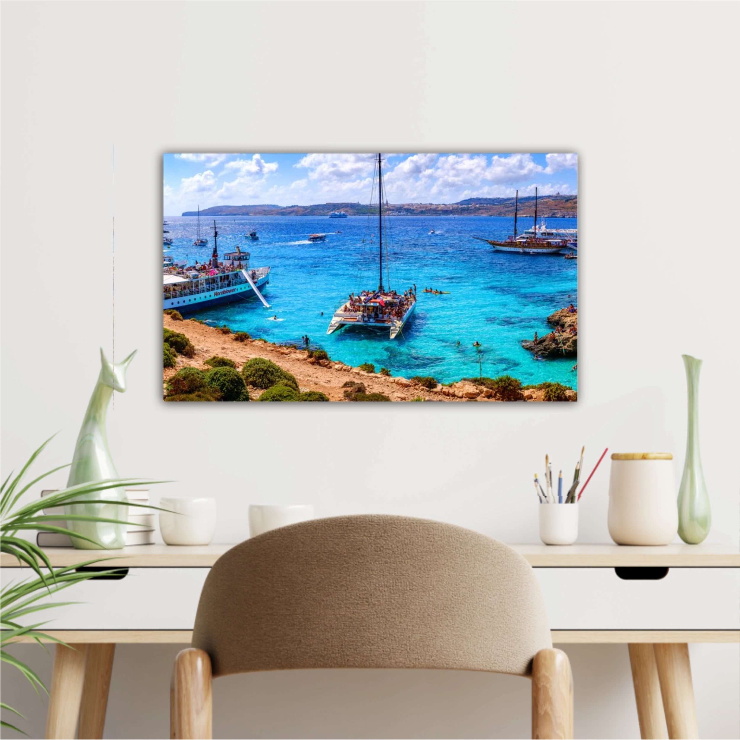 Comino, Malta. Tourists crowd at Blue Lagoon to enjoy the clear turquoise water on a sunny summer day with and boats on Comino island, Malta.