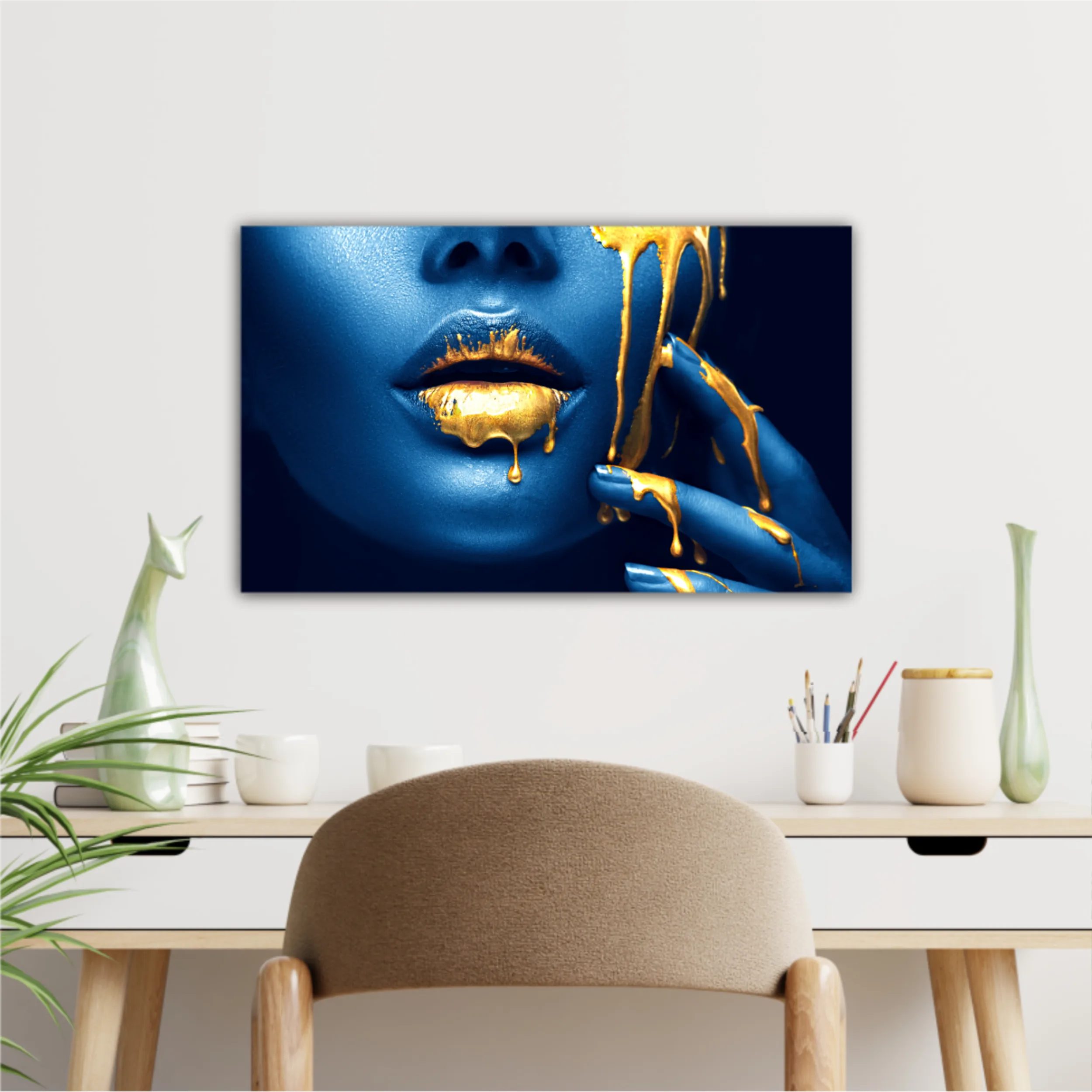 Lipgloss dripping from sexy lips, golden liquid drops on beautiful model girl mouth, gold metallic skin make-up. Beauty woman makeup close up