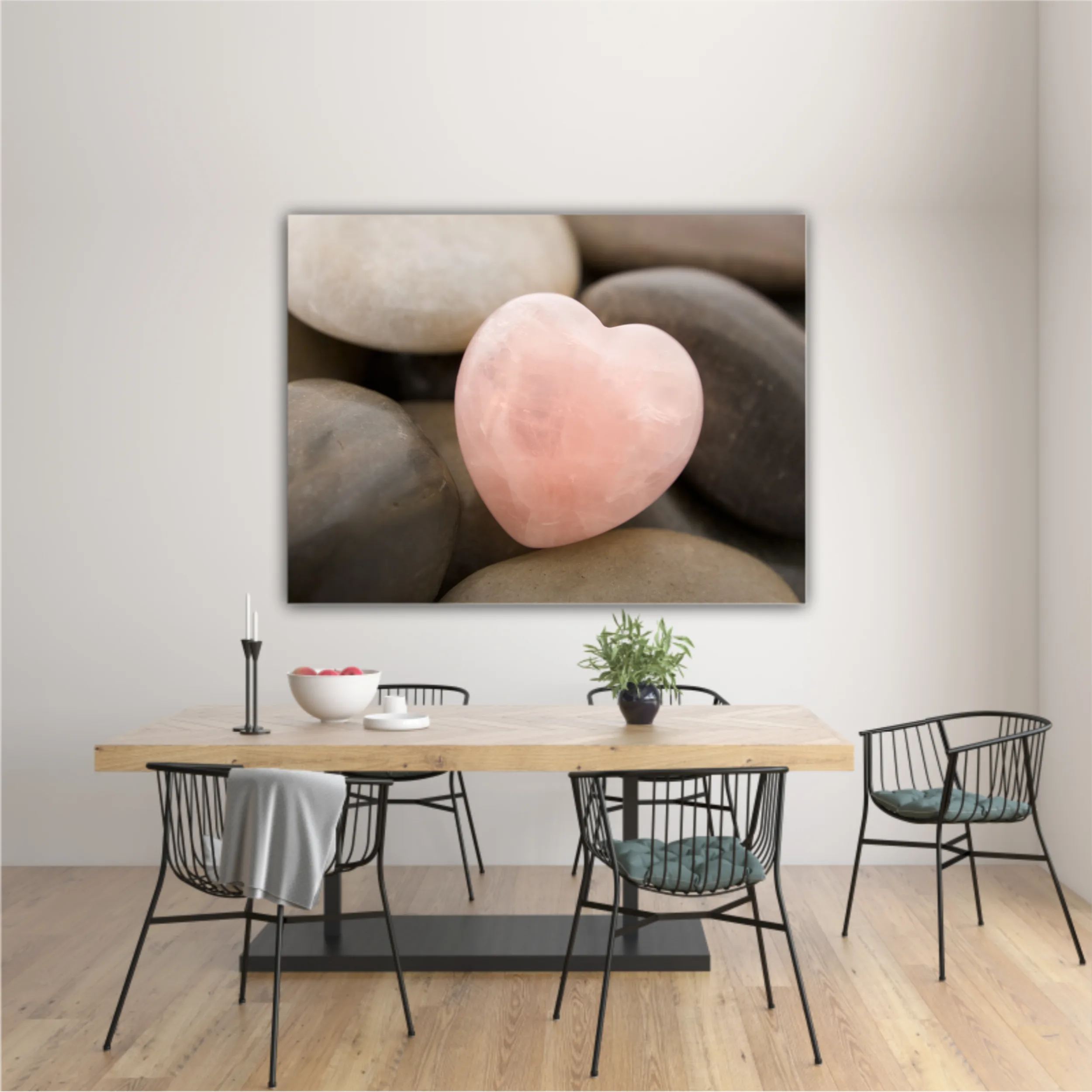 Rose quartz heart on pebbles