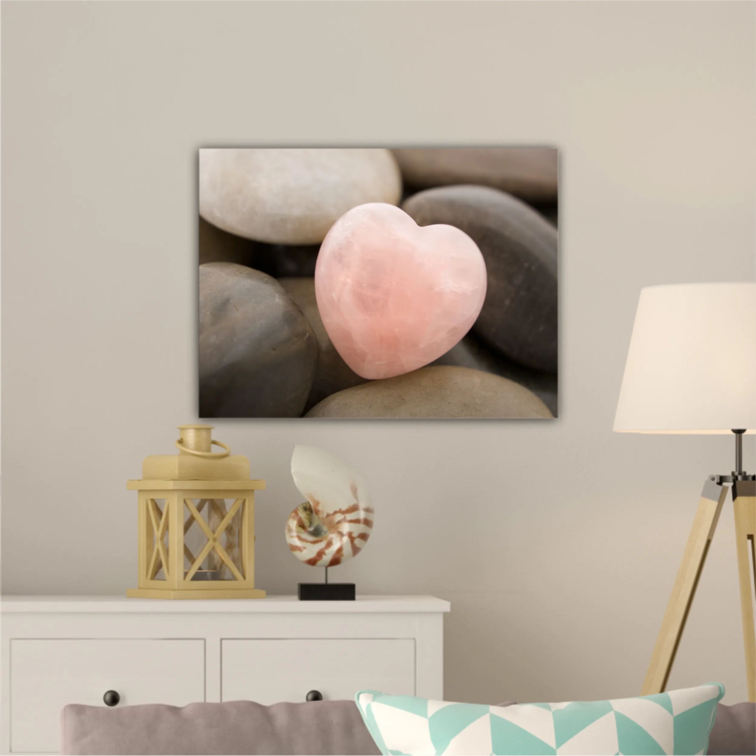 Rose quartz heart on pebbles