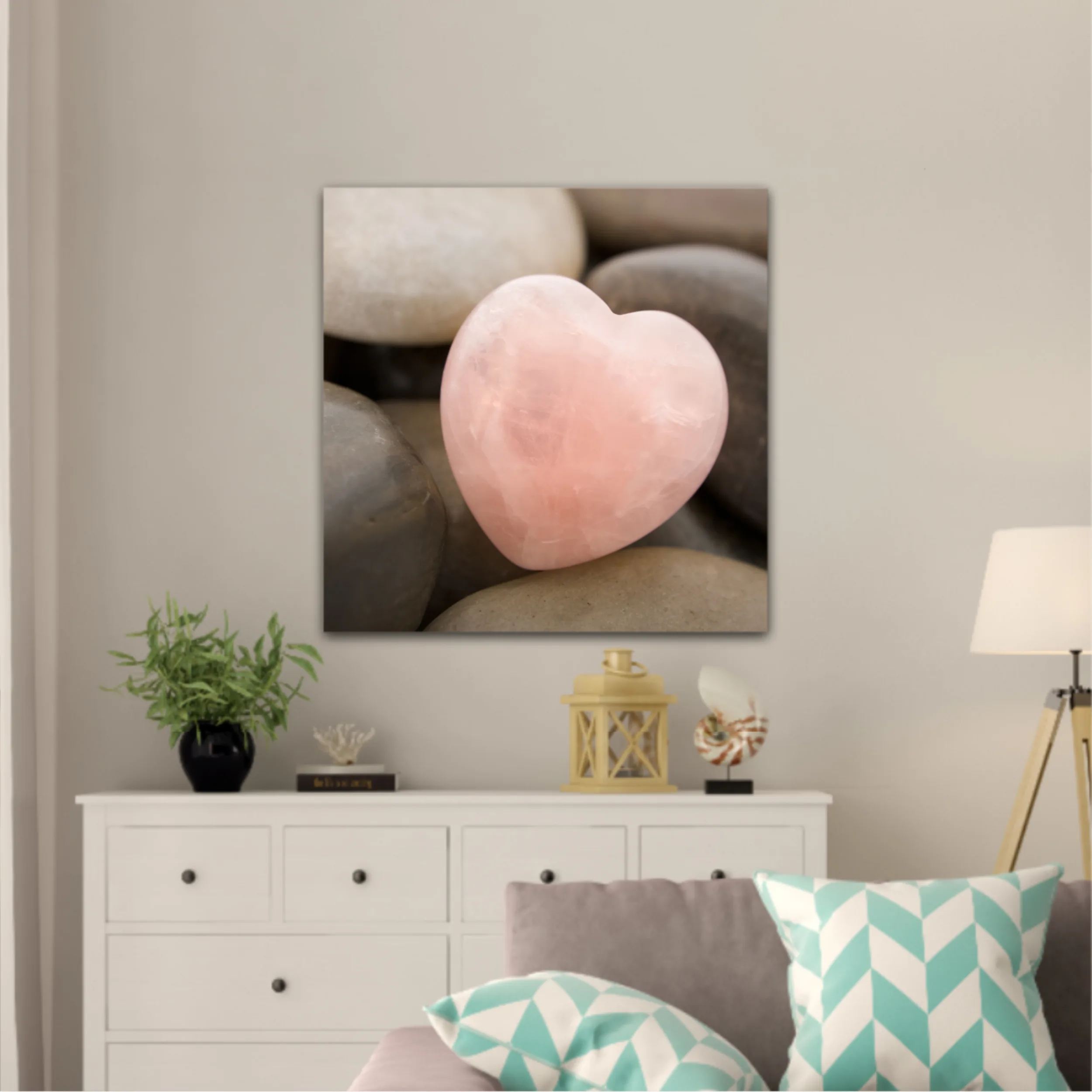 Rose quartz heart on pebbles