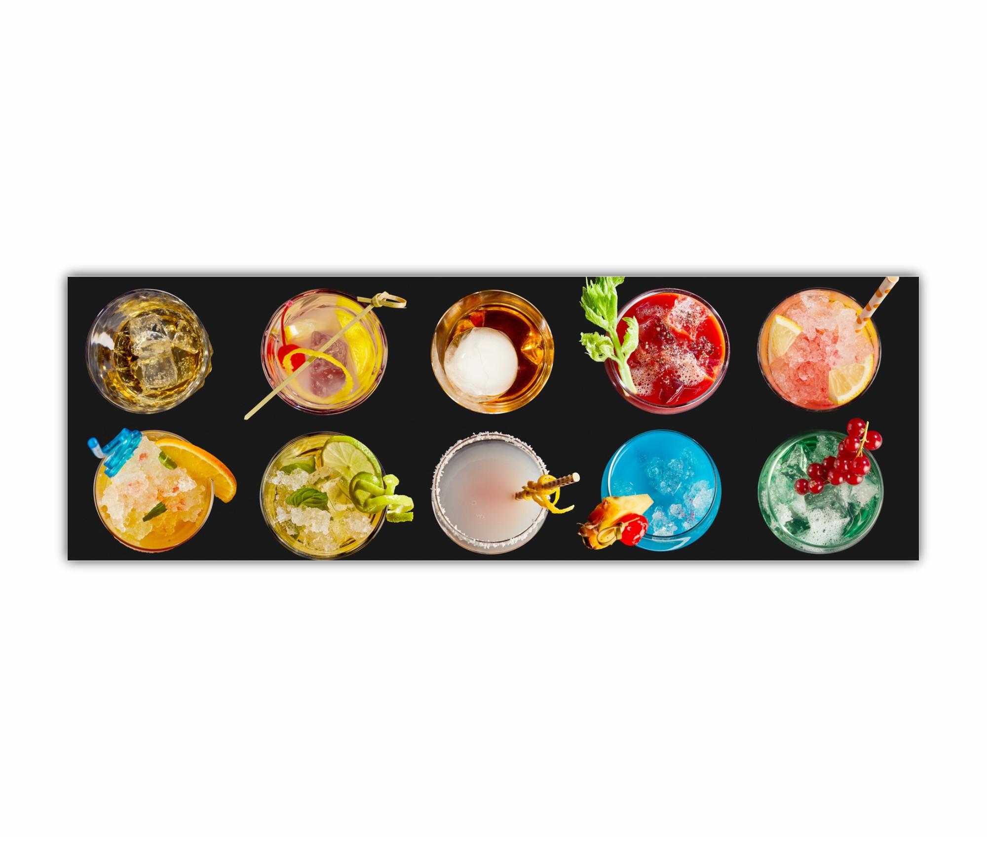 Panorama banner with an assortment of colorful exotic alcoholic cocktails served in glasses with garnishes viewed in two neat lines top down on black